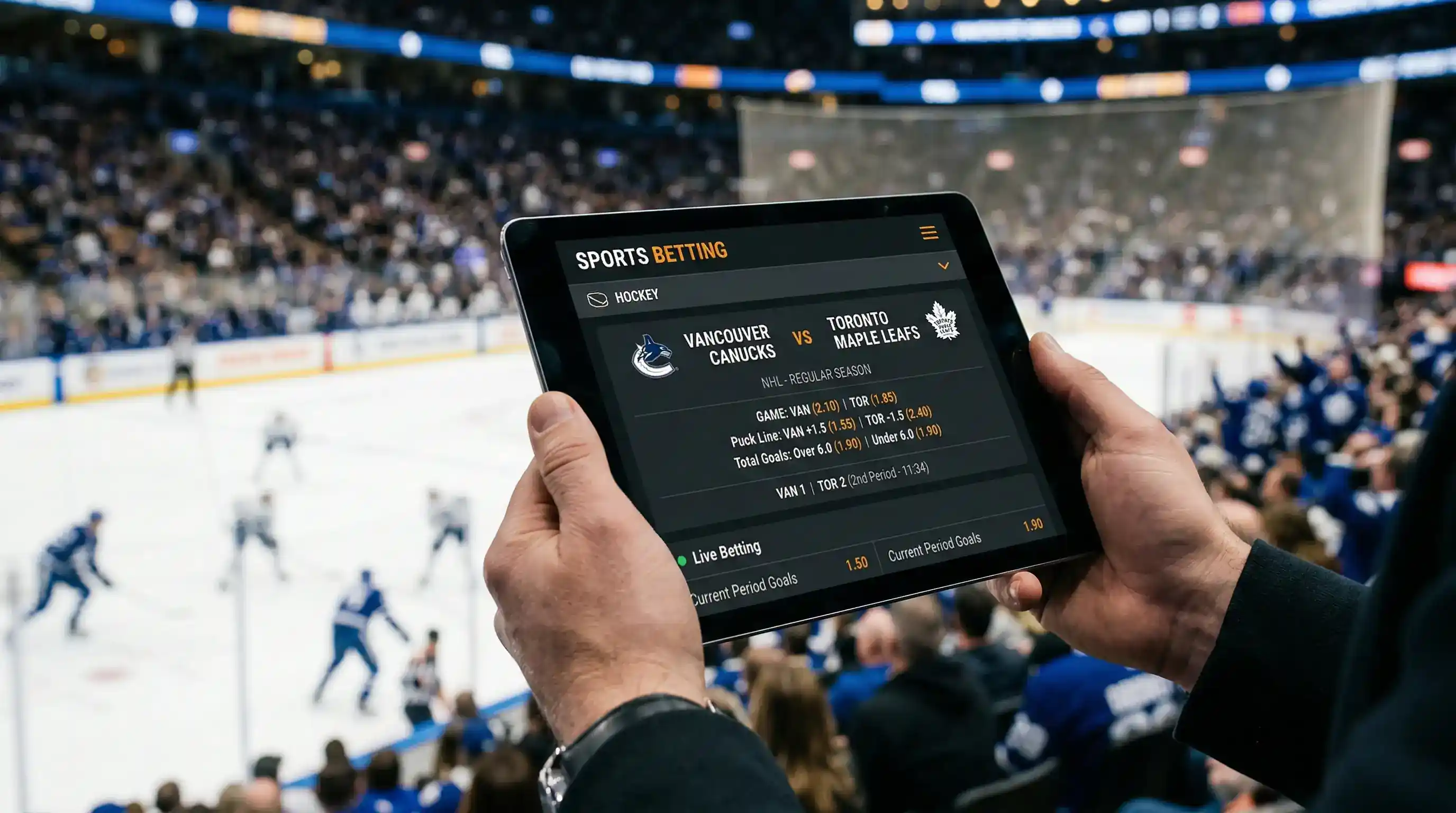 Tablet wyświetlający kursy bukmacherskie na mecze NHL z widocznym lodowiskiem w tle